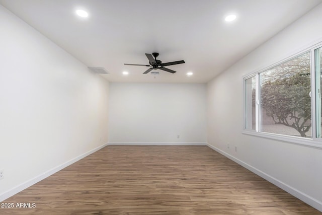 empty room featuring hardwood / wood-style flooring and ceiling fan