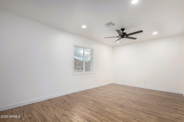 empty room with hardwood / wood-style flooring and ceiling fan