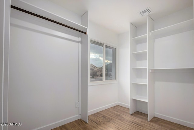 spacious closet featuring hardwood / wood-style floors