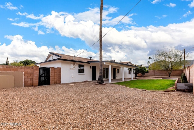 rear view of property featuring a patio