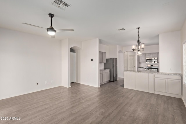 kitchen featuring arched walkways, visible vents, appliances with stainless steel finishes, and open floor plan