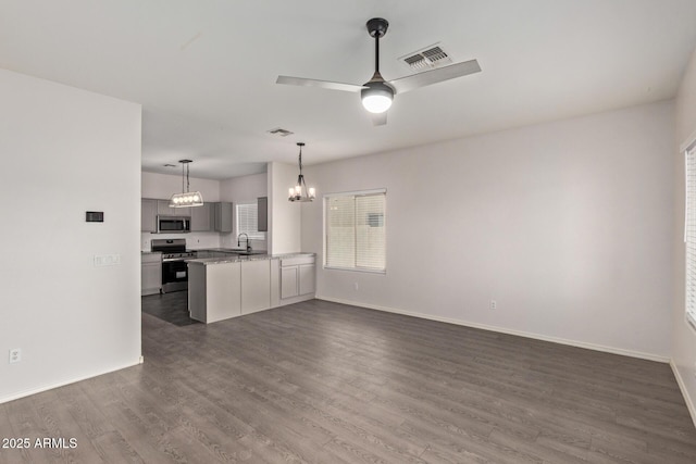 interior space with visible vents, open floor plan, dark wood-style floors, appliances with stainless steel finishes, and light countertops