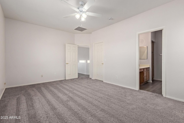 unfurnished bedroom with visible vents, baseboards, carpet, and ensuite bathroom