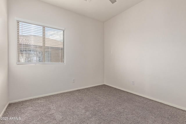 carpeted empty room with baseboards and ceiling fan