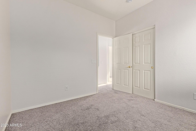 unfurnished bedroom with baseboards and carpet