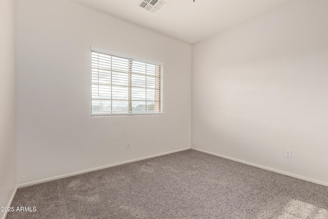 unfurnished room featuring visible vents, carpet flooring, and baseboards