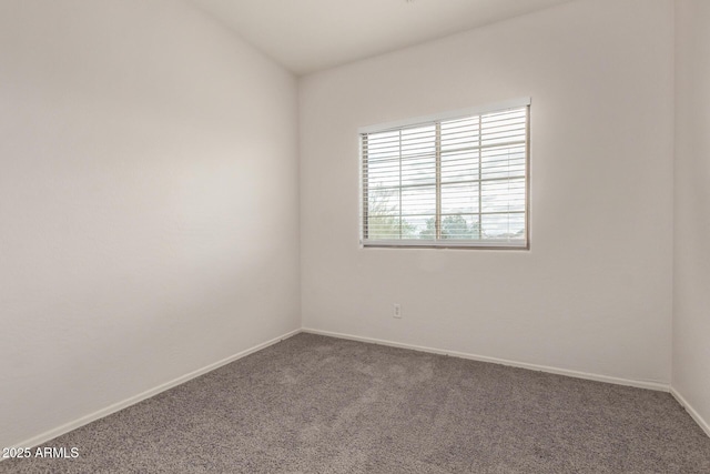 carpeted spare room with baseboards