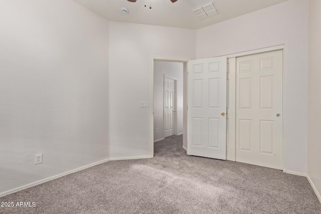 unfurnished bedroom with visible vents, a closet, carpet flooring, baseboards, and ceiling fan