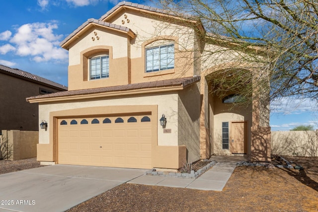 view of front of house featuring stucco siding, a tiled roof, concrete driveway, and a garage