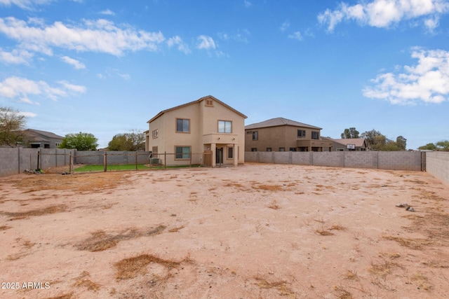 back of property featuring stucco siding and a fenced backyard