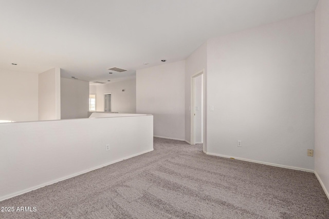 spare room featuring visible vents, baseboards, and carpet