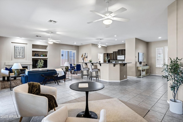 2260 E Binner Dr, Chandler, AZ 85225 - living room featuring recessed lighting, visible vents, light tile patterned floors, built in shelves, and ceiling fan