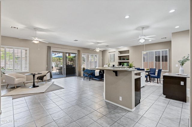 2260 E Binner Dr, Chandler, AZ 85225 - kitchen with light countertops, a kitchen bar, a ceiling fan, and open floor plan