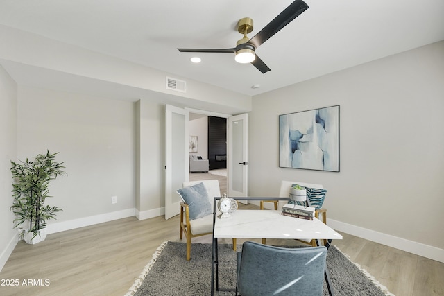 sitting room with light hardwood / wood-style flooring and ceiling fan