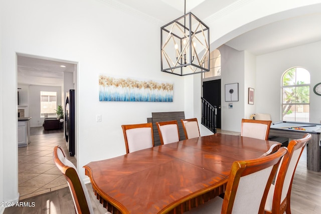 dining space featuring an inviting chandelier, crown molding, and hardwood / wood-style floors