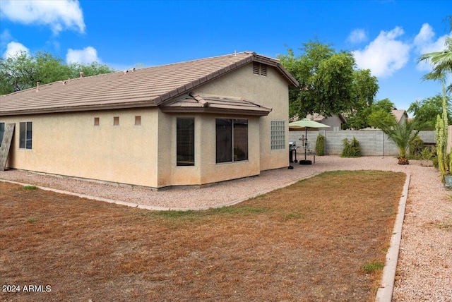 rear view of property with a lawn