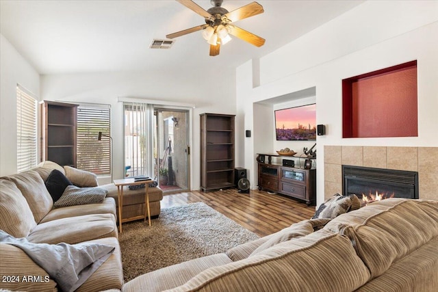 living room featuring ceiling fan, a fireplace, and hardwood / wood-style floors