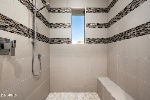 bathroom with a tile shower