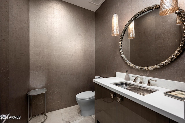 bathroom featuring tile patterned floors, vanity, and toilet