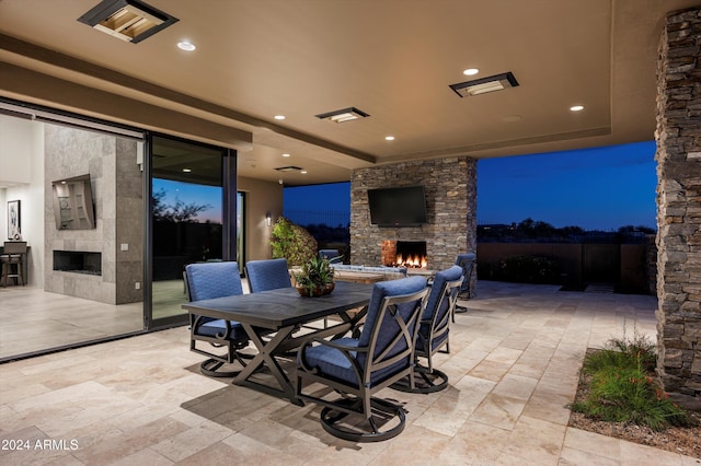 view of patio featuring an outdoor stone fireplace