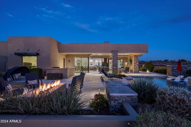 view of swimming pool featuring a fire pit and a patio area