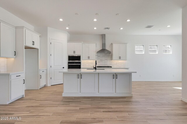 28266 N 134th Dr, Peoria, AZ 85383 - kitchen with stainless steel appliances, white cabinets, light countertops, and wall chimney range hood