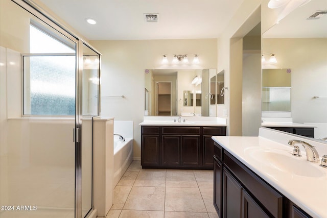 bathroom featuring vanity, tile patterned flooring, and plus walk in shower