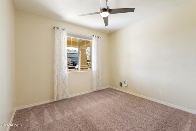 empty room featuring ceiling fan and carpet floors