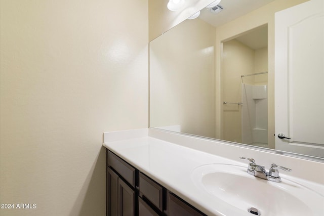 bathroom featuring vanity and a shower