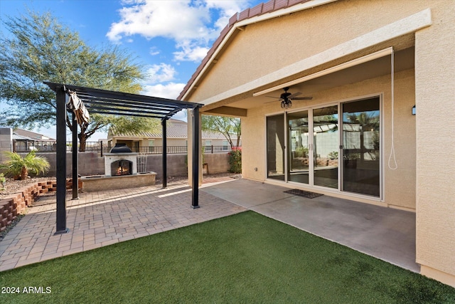 view of patio featuring ceiling fan, a pergola, and exterior fireplace