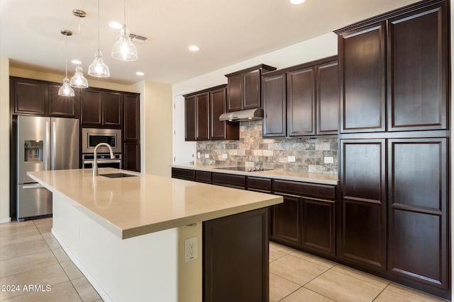 kitchen featuring hanging light fixtures, sink, a kitchen island with sink, and appliances with stainless steel finishes