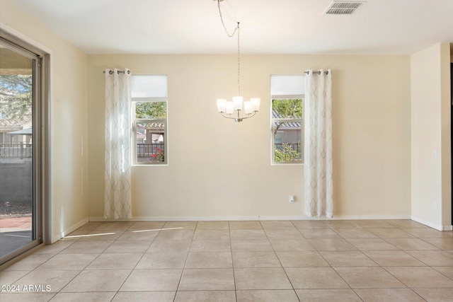 interior space with light tile patterned floors and a notable chandelier