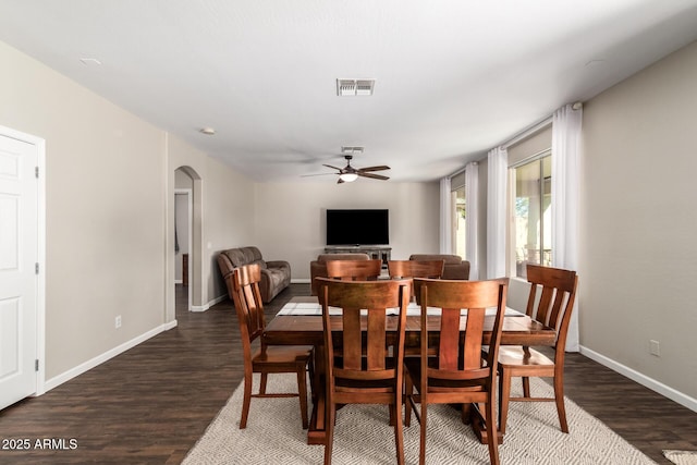 dining room with dark hardwood / wood-style flooring and ceiling fan