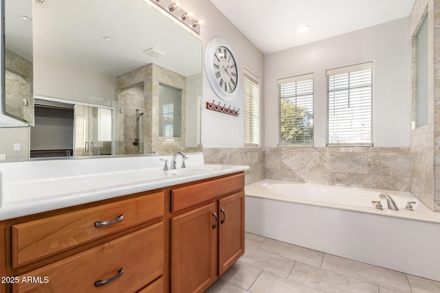 bathroom featuring vanity, tile patterned floors, and shower with separate bathtub