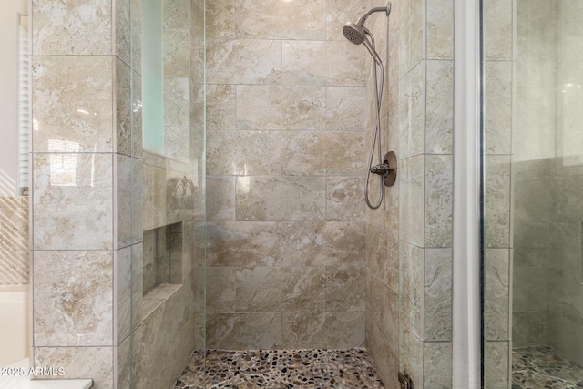 bathroom with a tile shower