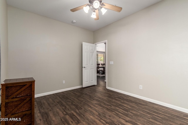 spare room featuring ceiling fan and dark hardwood / wood-style floors