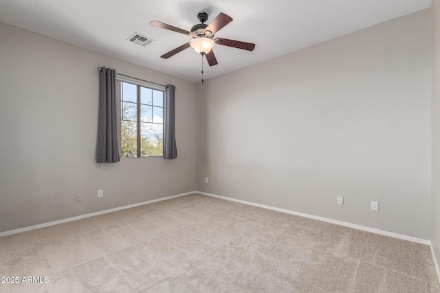 carpeted spare room with ceiling fan