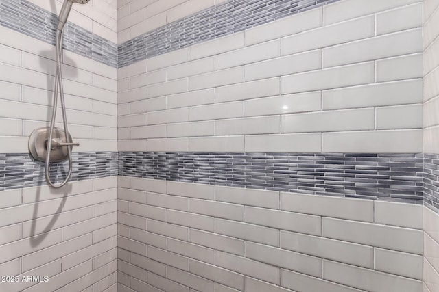 bathroom with a tile shower