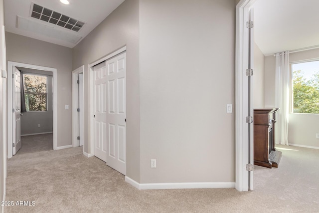 hallway with light colored carpet