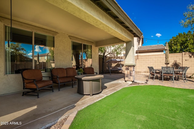 view of patio / terrace featuring an outdoor fire pit