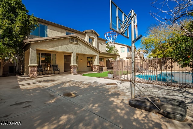 view of basketball court featuring a fenced in pool