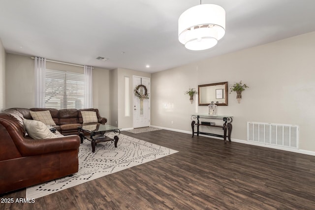 living room featuring dark wood-type flooring