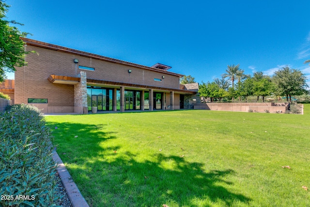 rear view of property featuring a yard