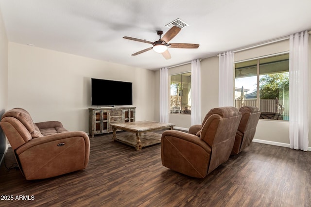 living room featuring ceiling fan and dark hardwood / wood-style flooring