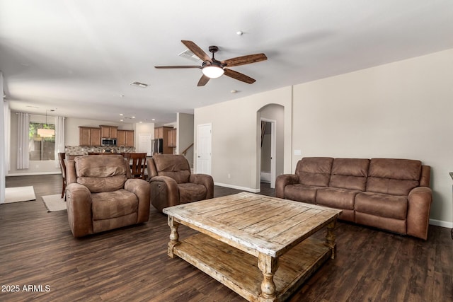 living room featuring dark hardwood / wood-style flooring and ceiling fan