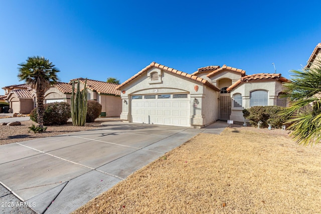 mediterranean / spanish-style home with a garage