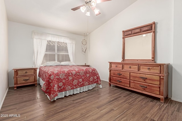 bedroom featuring dark wood-type flooring, ceiling fan, and vaulted ceiling