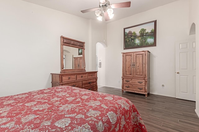 bedroom with dark hardwood / wood-style flooring, a towering ceiling, and ceiling fan