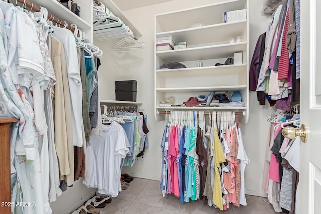 spacious closet featuring light tile patterned floors