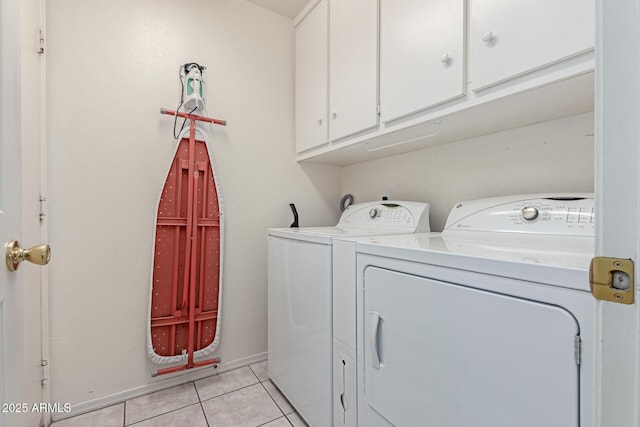 washroom featuring cabinets, separate washer and dryer, and light tile patterned floors